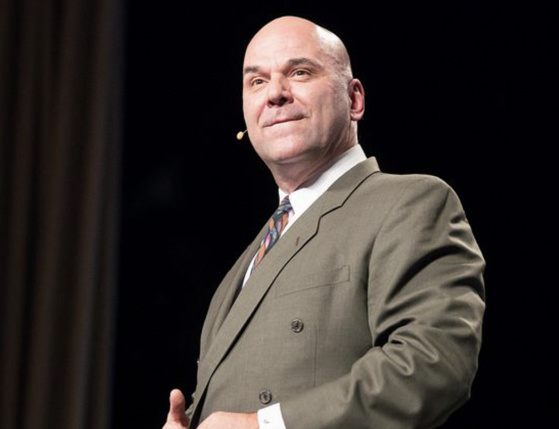 Marshall Sylver speaking on stage